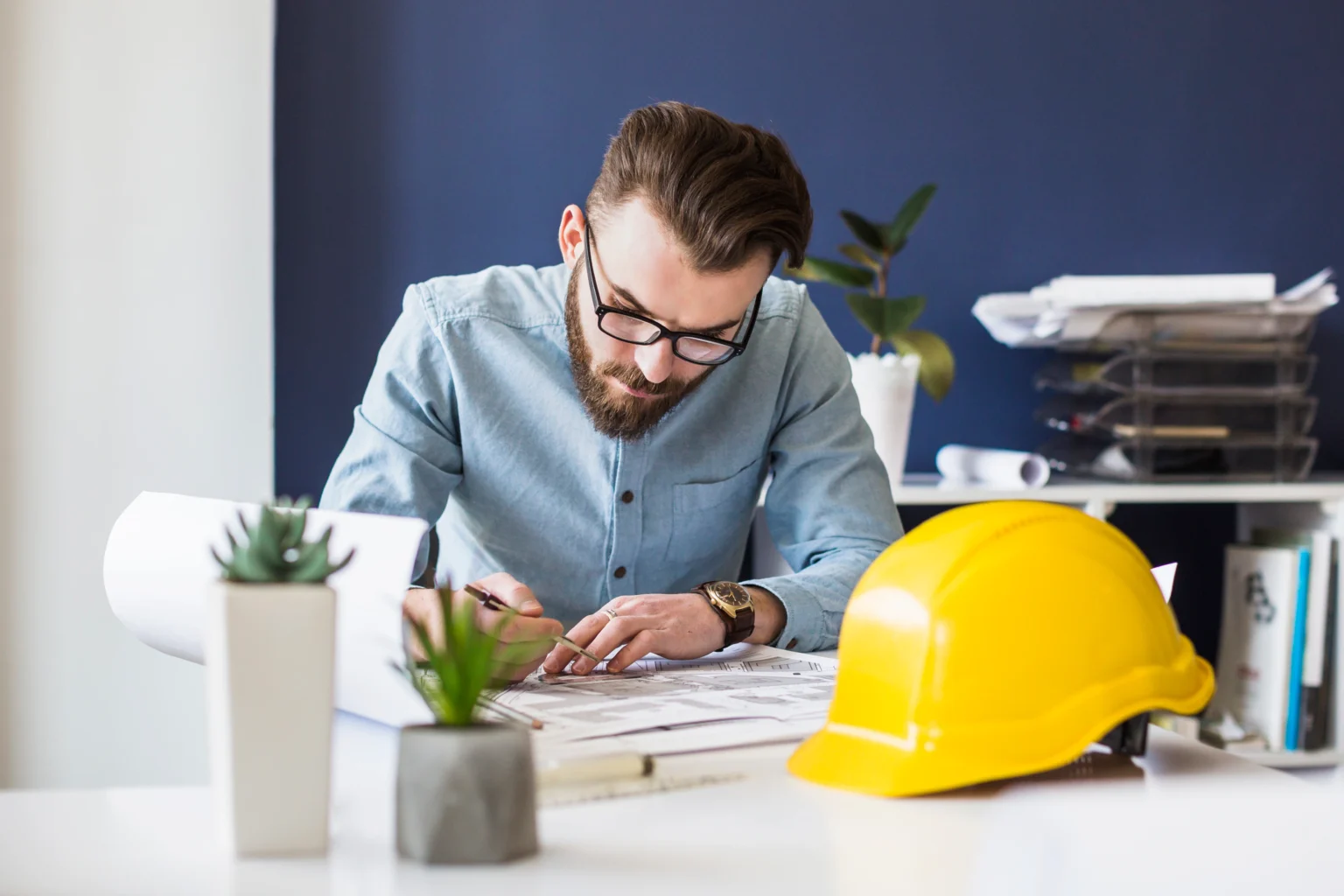 attractive-male-engineer-drawing-plan-blueprint-workplace-1-1536x1024.webp